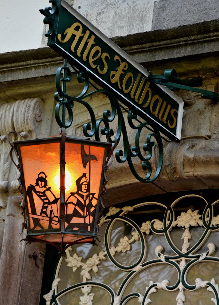 Decorative lantern with intricate design outside Altes Zollhaus.